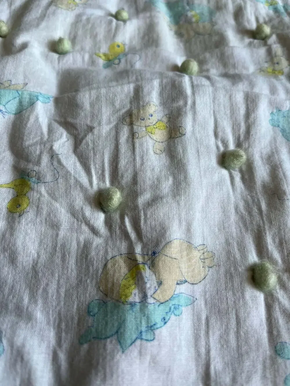 Vintage Style Baby Nursery Crib Quilt with Pom-Pom Accents and Animal Print